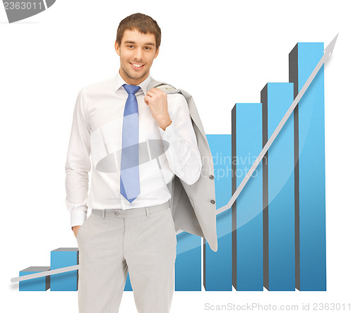 Image of handsome businessman with big 3d chart