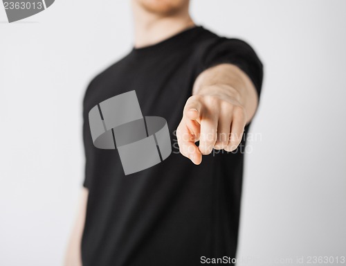 Image of man pointing his finger at you