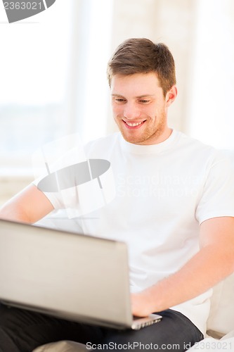 Image of man working with laptop at home