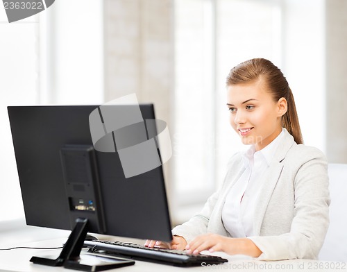 Image of businesswoman with computer in office