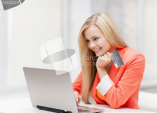 Image of businesswoman with laptop and credit card