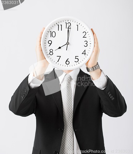 Image of man with wall clock