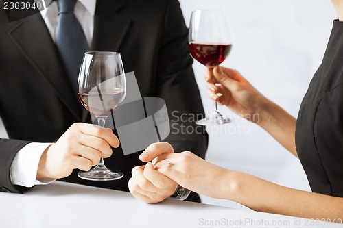 Image of engaged couple with wine glasses