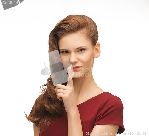 Image of woman showing silence gesture