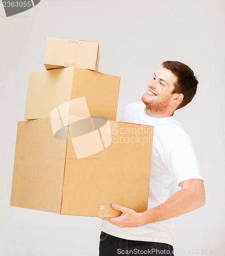 Image of young man carrying carton boxes