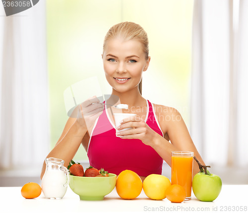 Image of young woman eating healthy breakfast