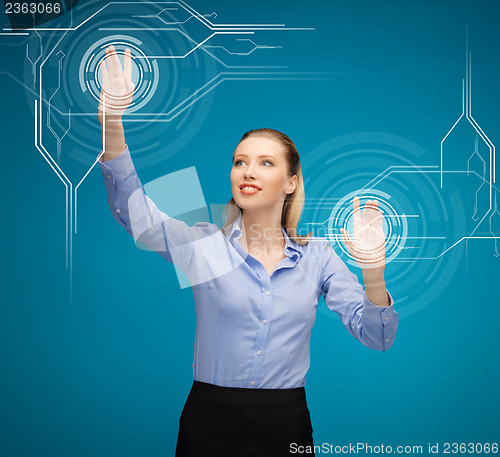 Image of businesswoman touching virtual screen