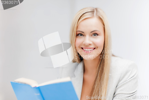 Image of young woman reading book