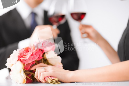 Image of engaged couple with wine glasses