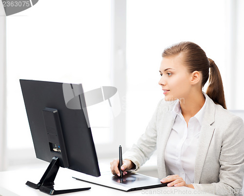 Image of businesswoman with drawing tablet in office