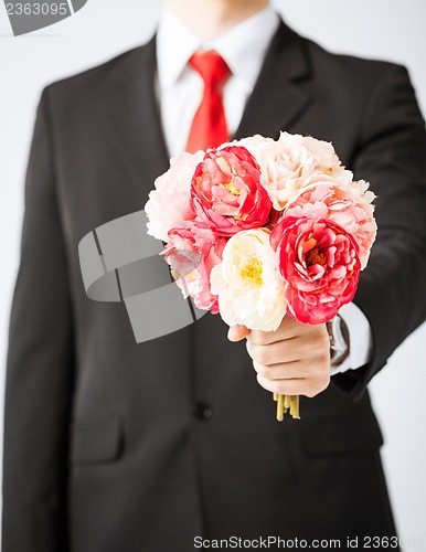 Image of man giving bouquet of flowers