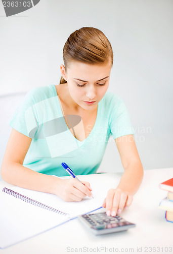 Image of student girl with notebook and calculator