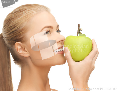 Image of woman smelling apple