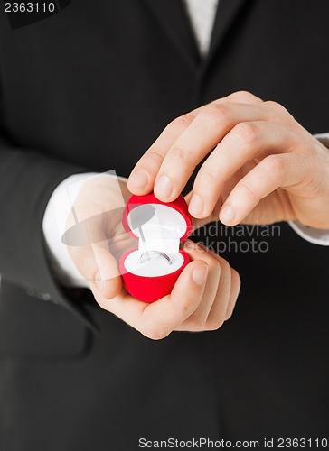 Image of man with gift box and wedding ring