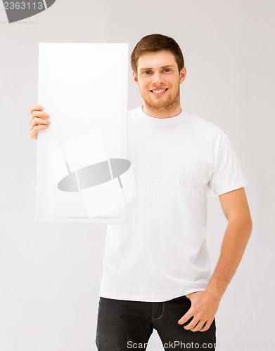 Image of young man holding white blank board