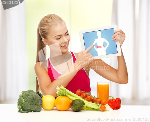 Image of woman with fruits, vegetables and tablet pc
