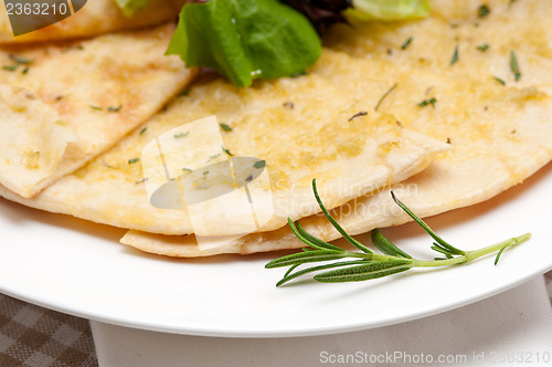 Image of garlic pita bread pizza with salad on top