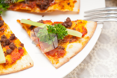 Image of Turkish beef pizza with cucumber on top