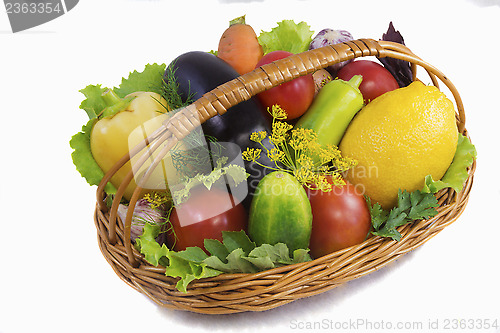 Image of Basket with fruits and vegetables , photographed on a white back