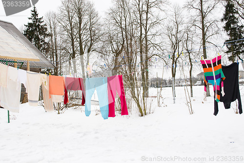 Image of colorful wash clothes loundry dry rope winter snow 