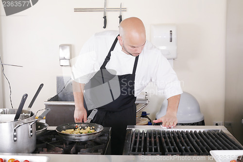 Image of professional chef cleaning the kitchen 