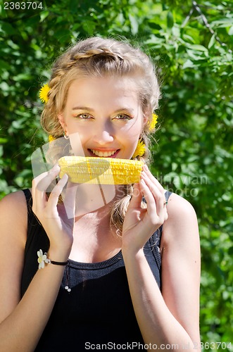 Image of woman eating corn-cob