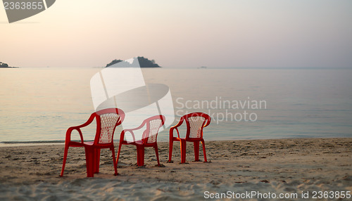 Image of Empty beach three chair "watching" ; the sunset
