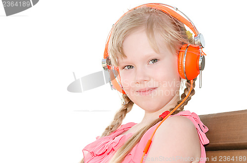 Image of Girl with pigtails listening language lessons in headphones isol