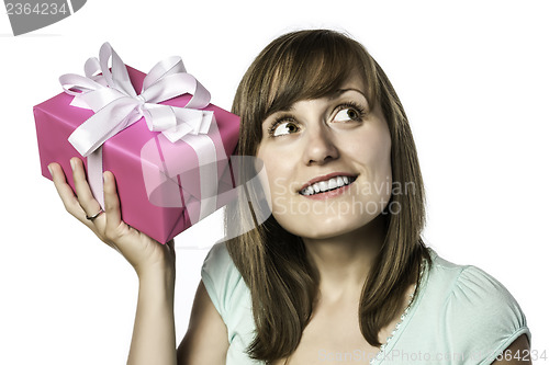 Image of pretty girl listens to a gift