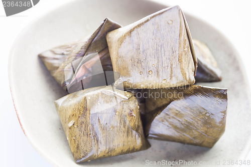 Image of Stuffed dough pyramid dessert on plate up close