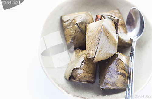 Image of Thai dessert stuffed dough pyramid and spoon