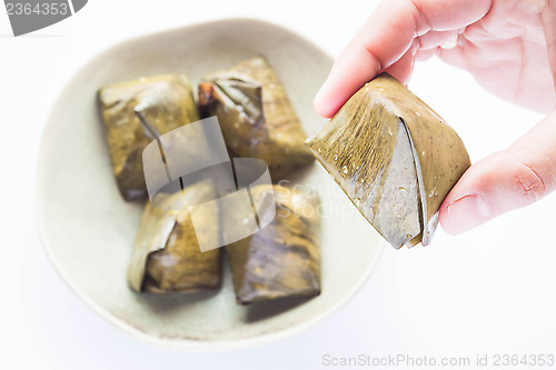 Image of Hand hold stuffed dough pyramid dessert