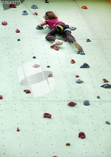 Image of child climbing up the wall