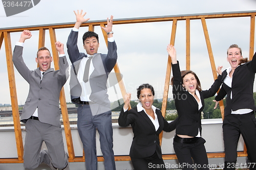 Image of Successful business team cheering and rejoicing