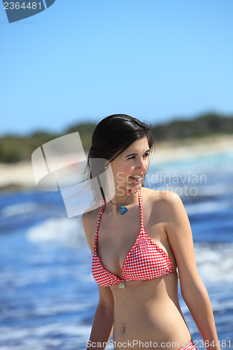 Image of Beautiful young woman at the seaside