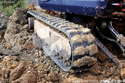 Image of Digger's tracks on rubble, soil and brick