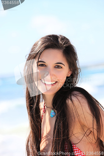 Image of Portrait of a beautiful woman at the beach