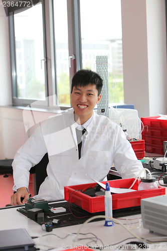 Image of Smiling Asian man working in a laboratory