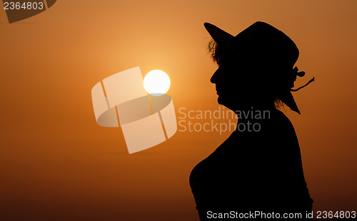 Image of Silhouette woman portrait against orange sunset