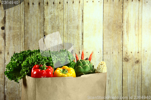 Image of Bag of Grocery Produce Items on a Wooden Plank