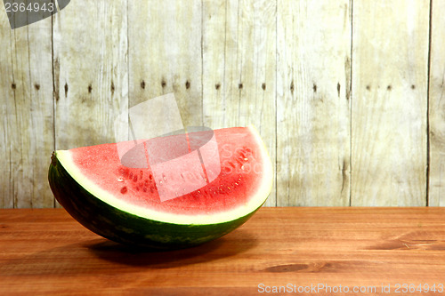 Image of Fruit Sliced Sitting on a Wooden Surface