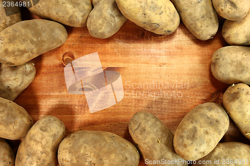 Image of Russet Potatoes on a Wooden Background