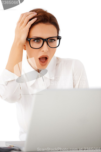 Image of Woman looking at her laptop in horror