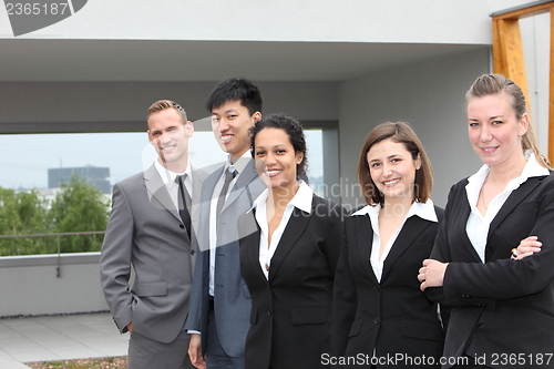 Image of Confident business team standing together outdoors