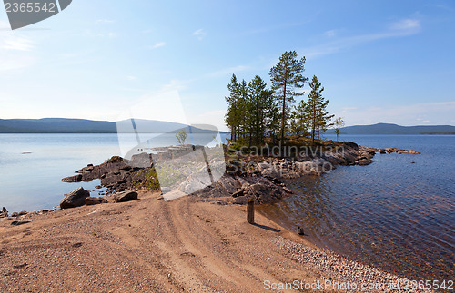 Image of A picturesque lake with a pebble beach in the north of Russia