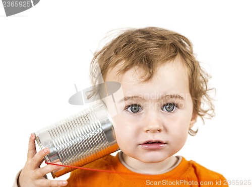 Image of child with tin can phone looking to camera