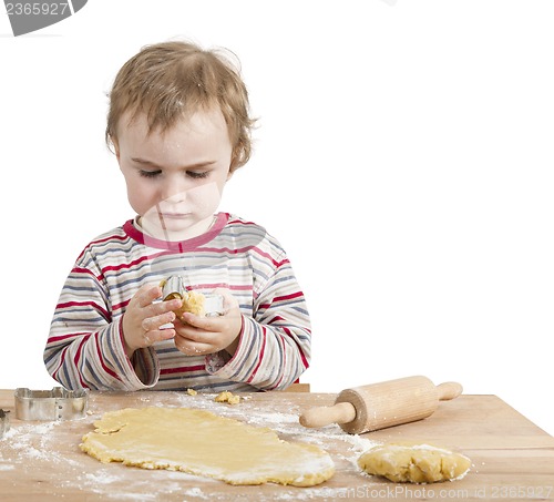 Image of young child with rolling pin and dough