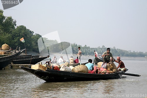 Image of Wooden boat crosses the Ganges River in Gosaba, West Bengal, India