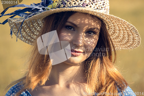 Image of Girl with a straw hat