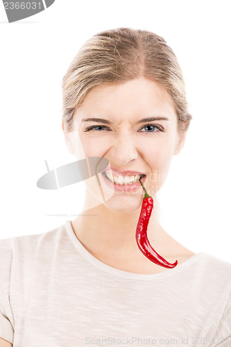 Image of Woman with a silly face holding a red chilli pepper